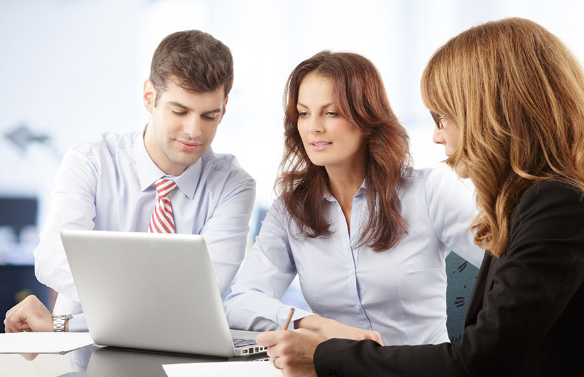 Agents looking at laptop